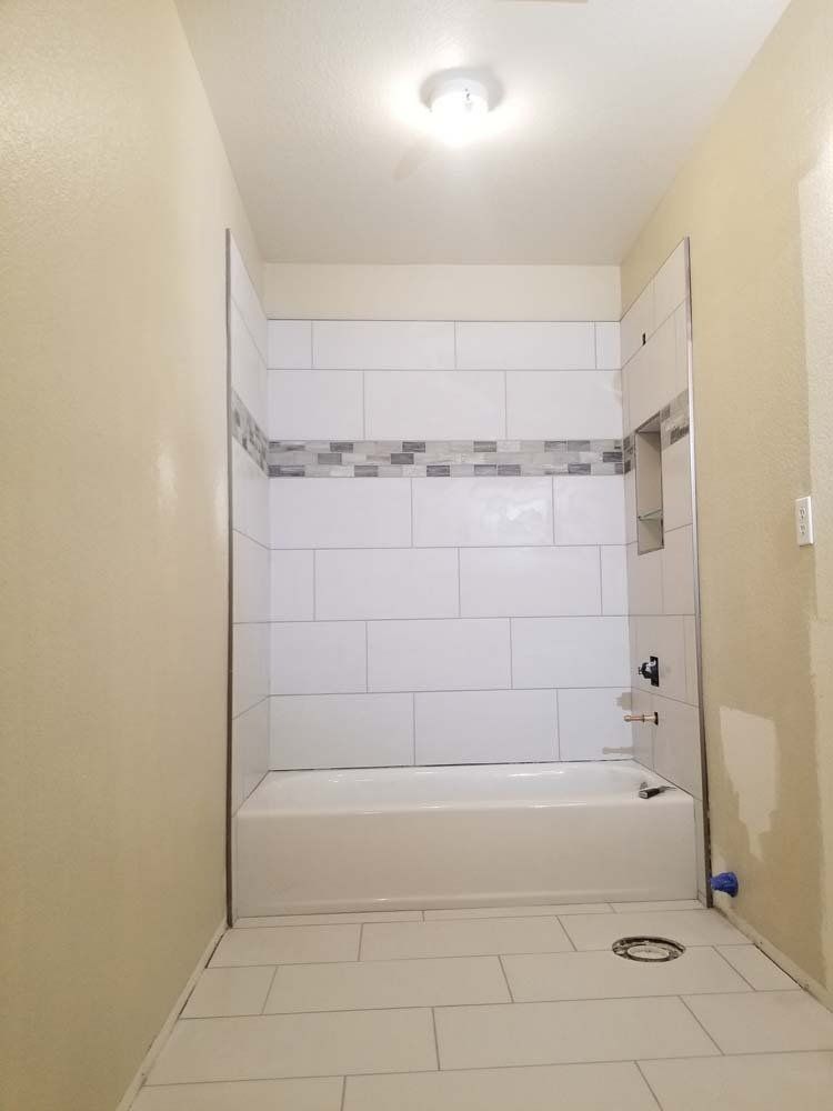 A bathroom with a bathtub and a shower.