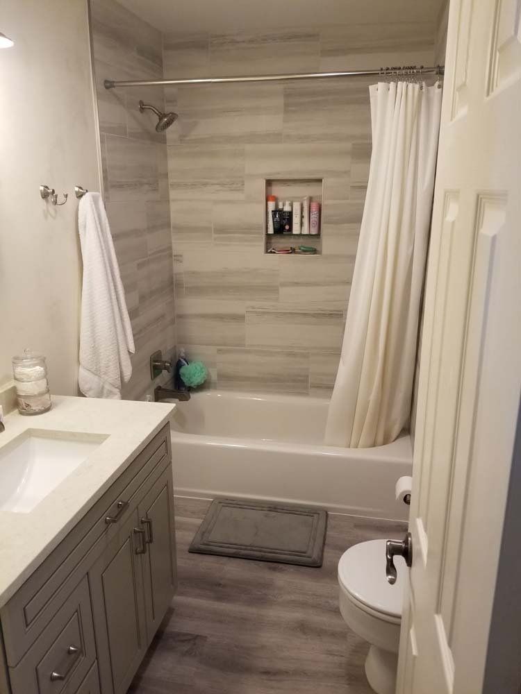 A bathroom with a sink , toilet , bathtub and shower curtain.