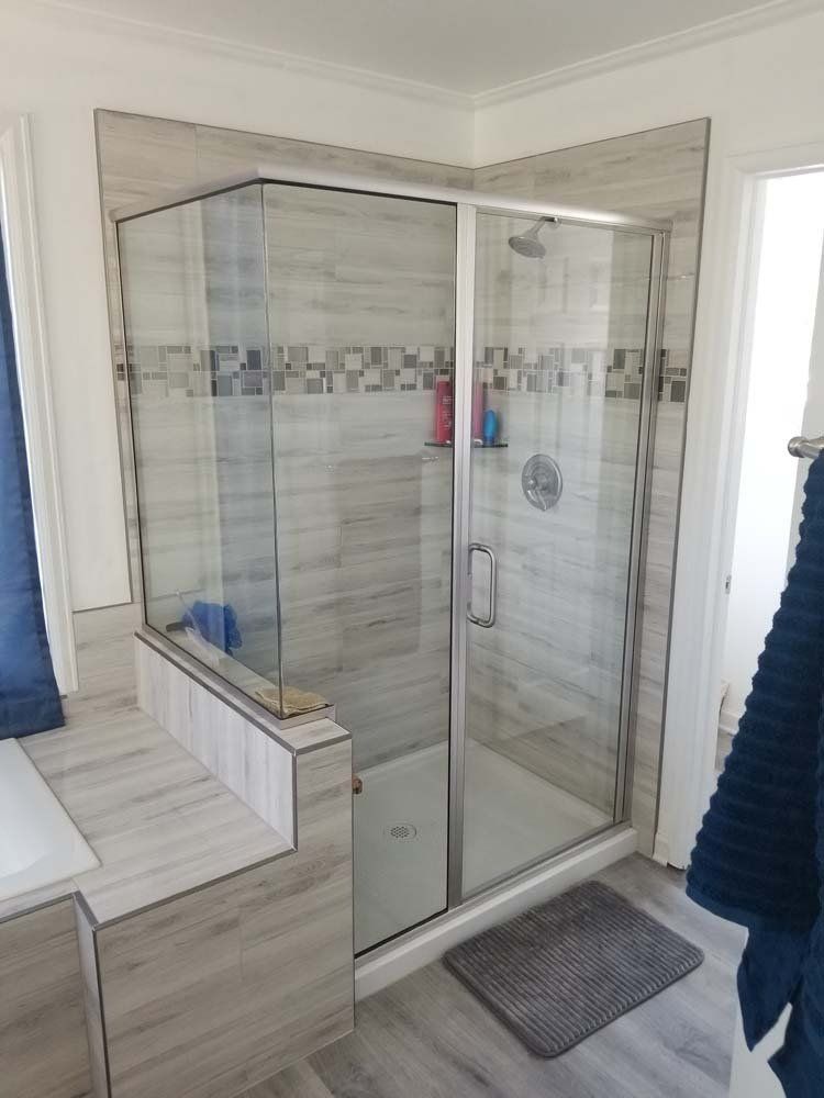 A bathroom with a walk in shower and a bathtub.