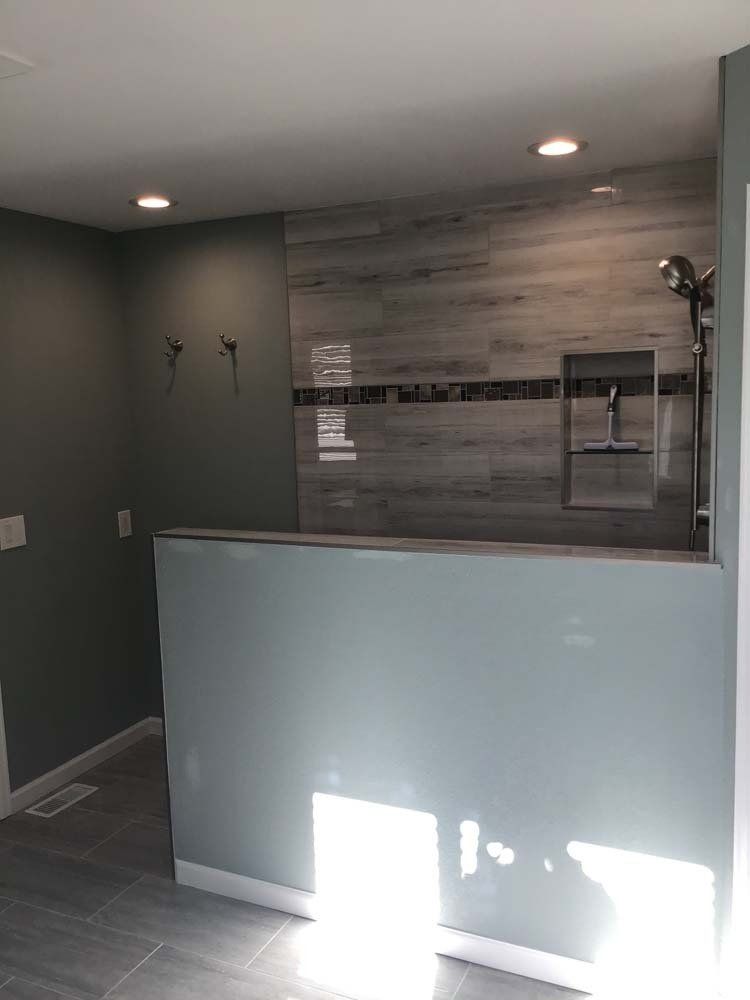 A bathroom with a shower and a sink in it.