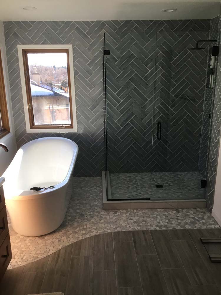 A bathroom with a bathtub and a walk in shower.