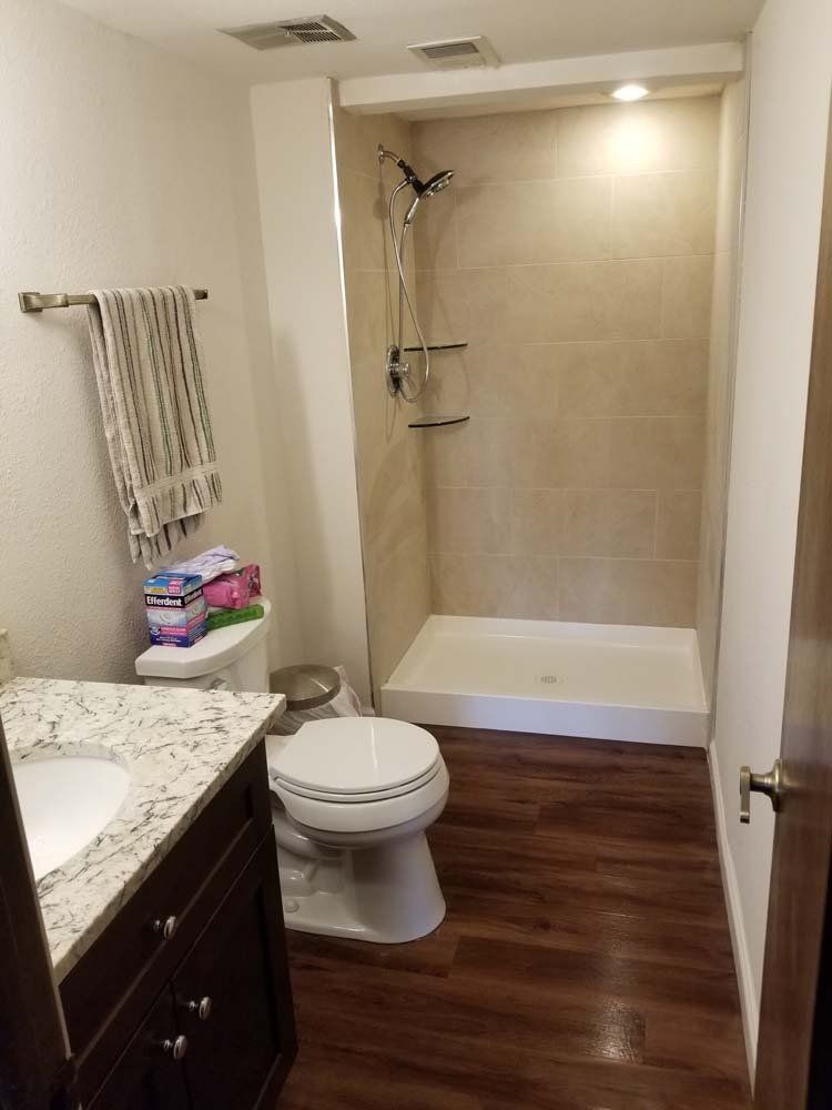A bathroom with a toilet , sink , and shower.