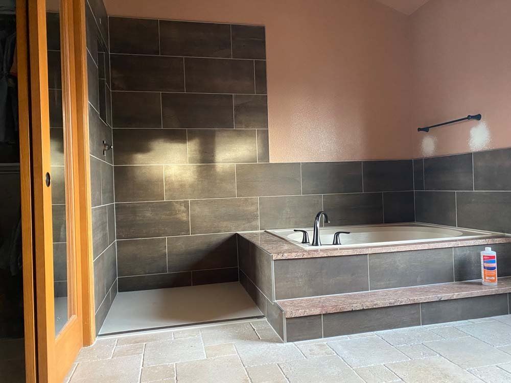 A bathroom with a bathtub and a shower.