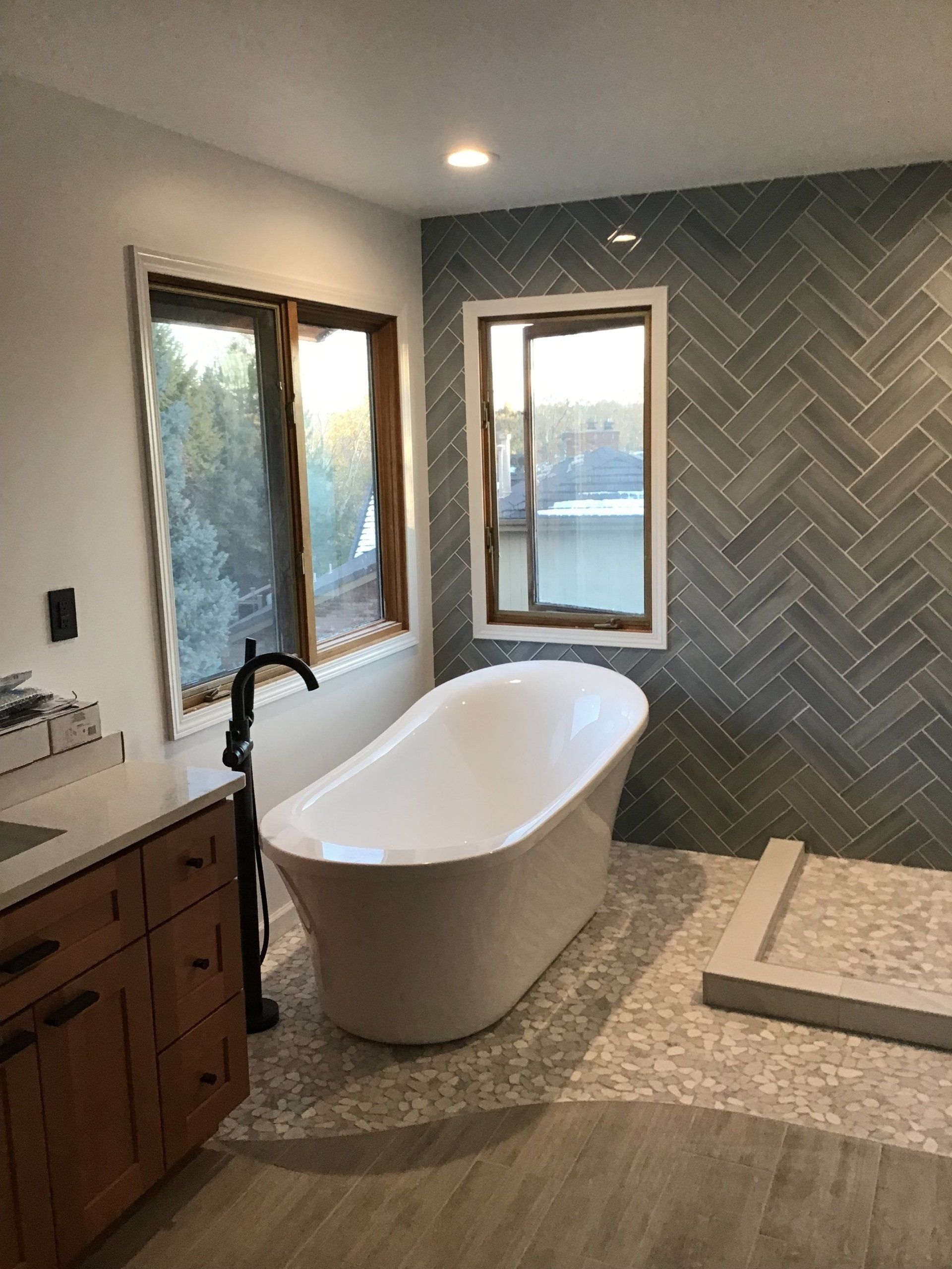 A bathroom with a bathtub , sink , and shower.