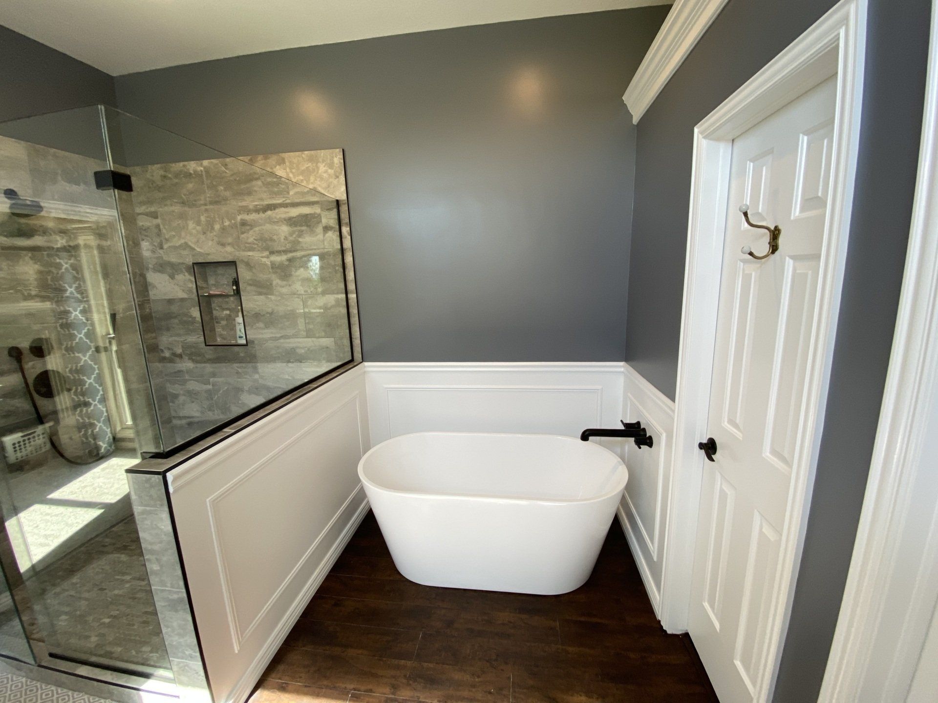 A bathroom with a tub and a walk in shower