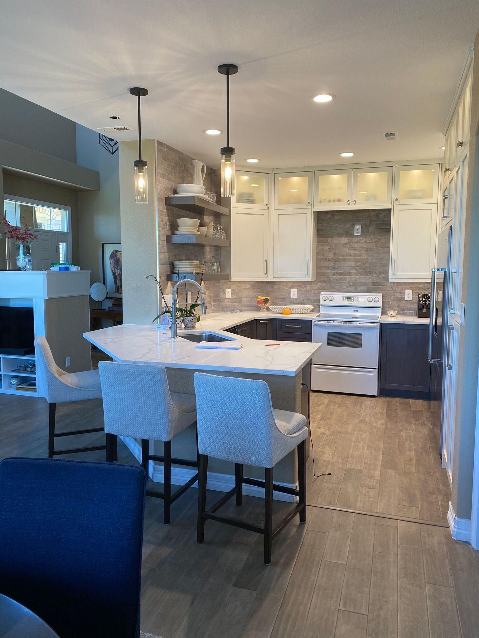 A kitchen with a large island and chairs in it
