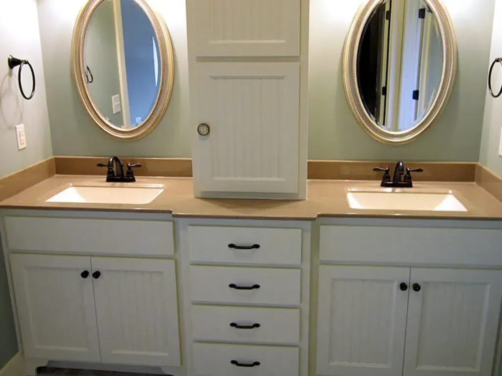 A bathroom with two sinks and two mirrors