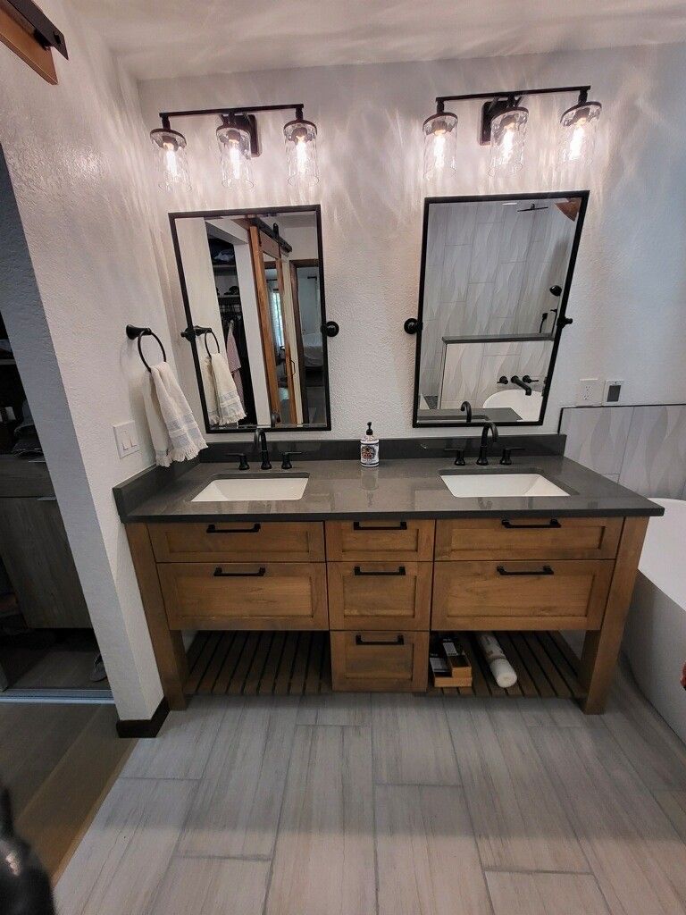 A bathroom with two sinks and two mirrors.