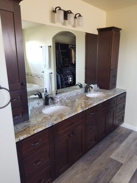 A bathroom with two sinks and a large mirror