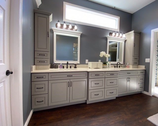 A bathroom with two sinks and two mirrors.