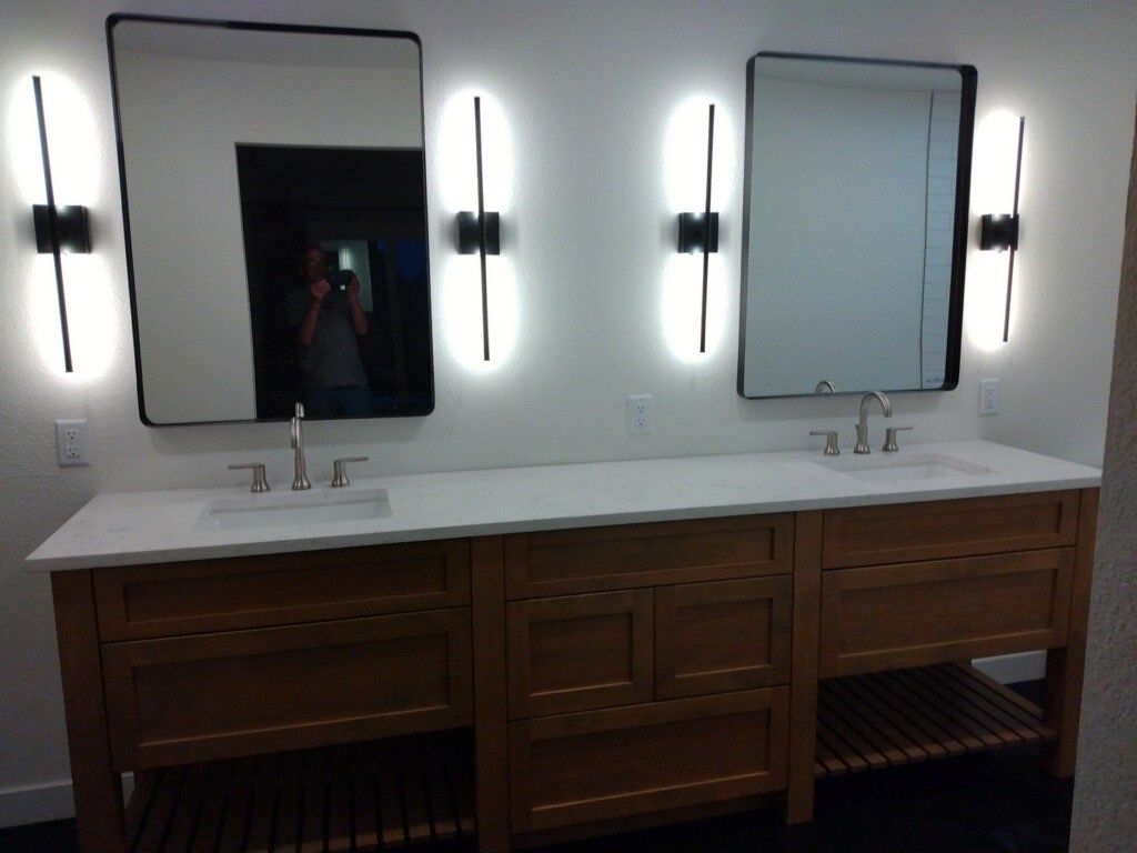 A bathroom with two sinks and two mirrors
