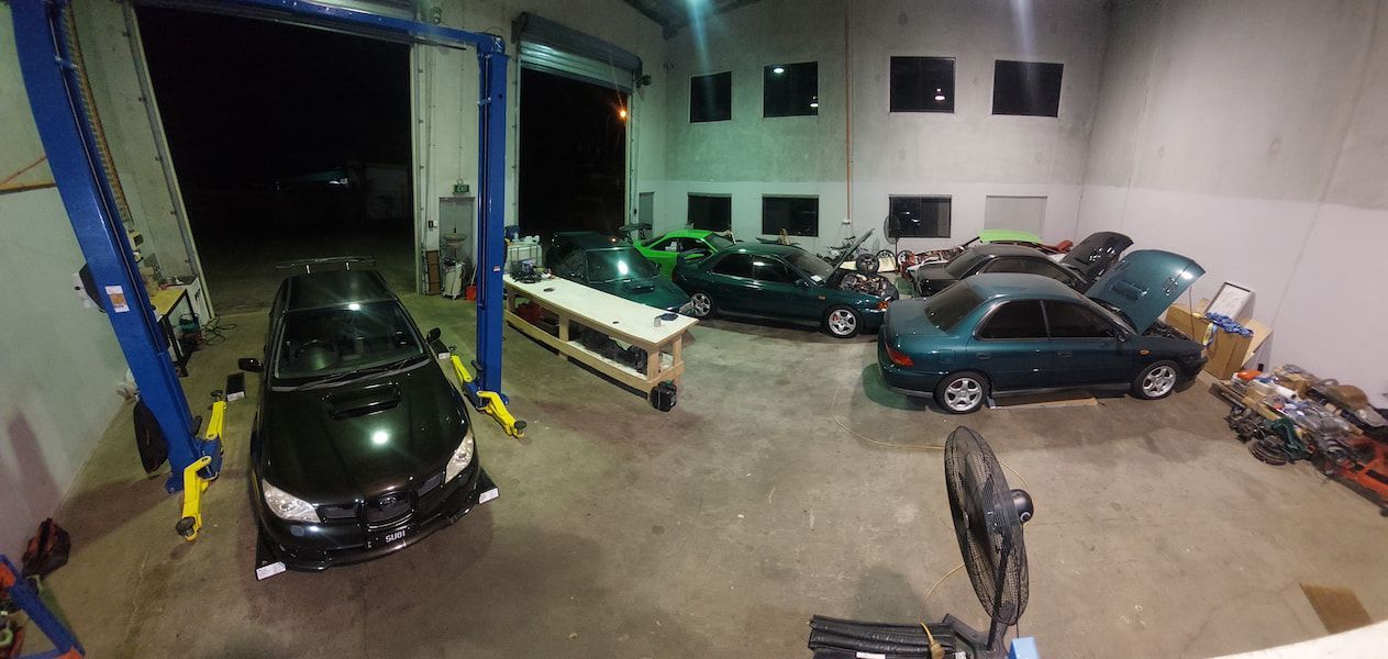 A Garage Filled with Cars and A Lift — Wilkomotive Mechanical in Bentley Park, QLD
