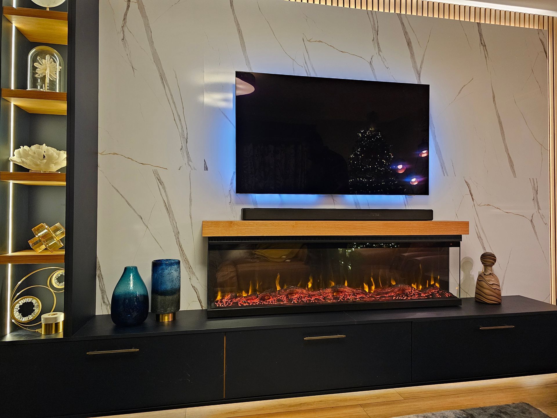 Feature Wall Bespoke fitted media wall with LED lighting and marble-effect backdrop by QM Furniture
