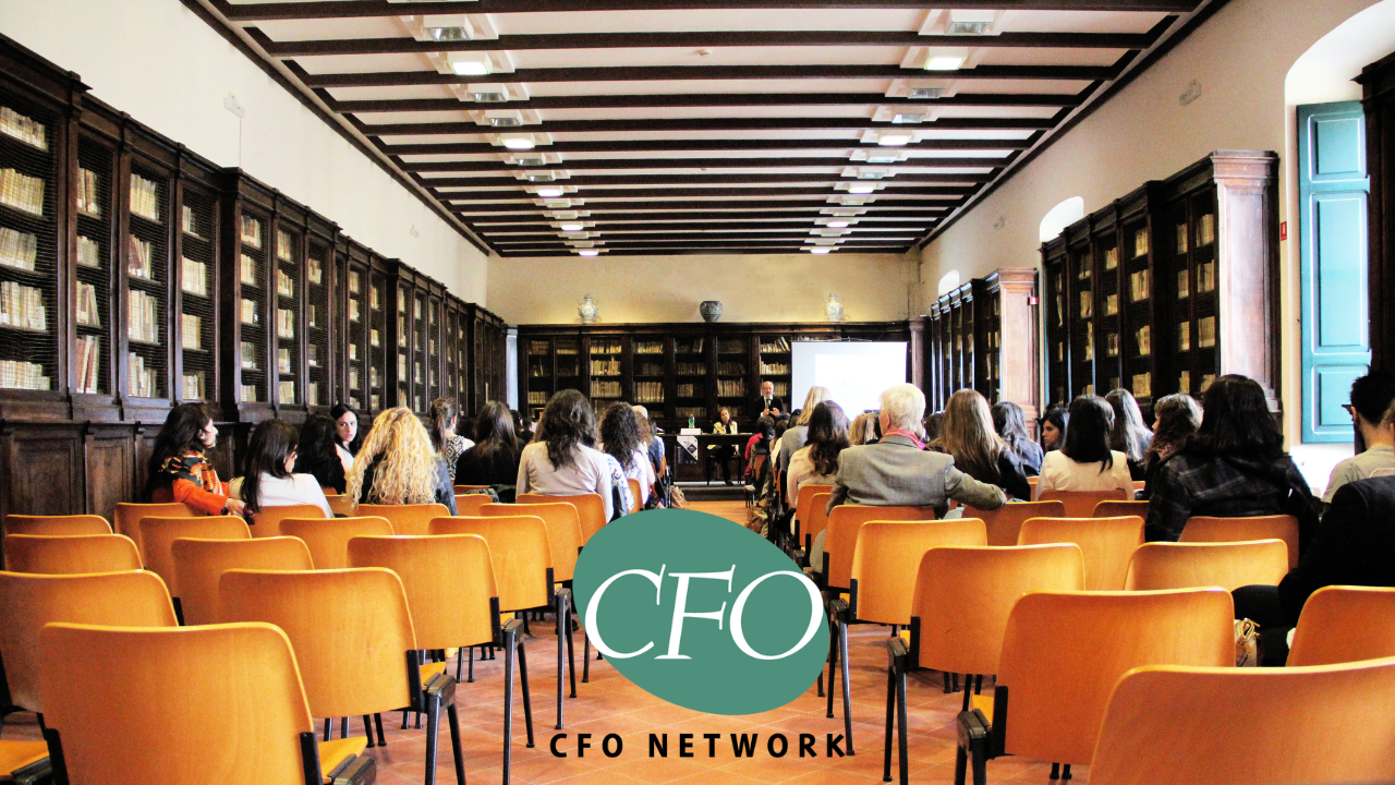 A group of people are sitting in rows of chairs in a lecture hall at CFO Network in North Little Rock, Arkansas