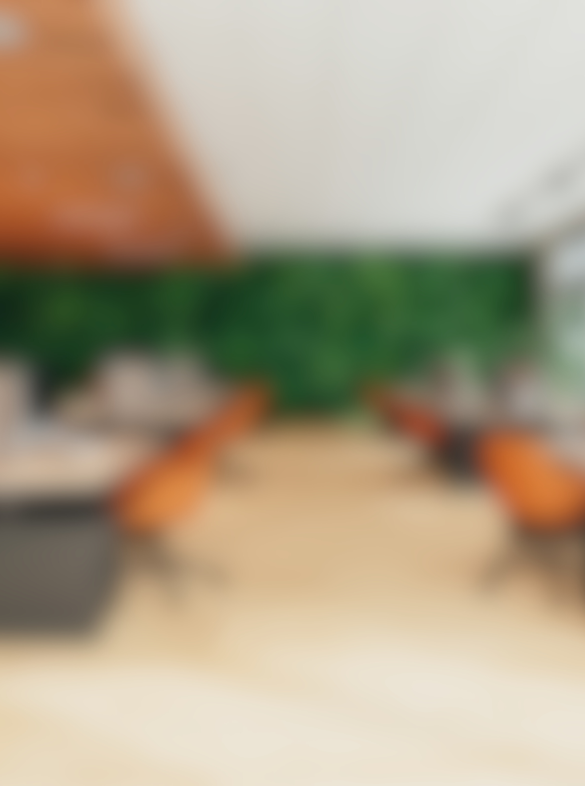 A blurry picture of a accounting office in North Little Rock, Arkansas with tables and chairs and a green wall.