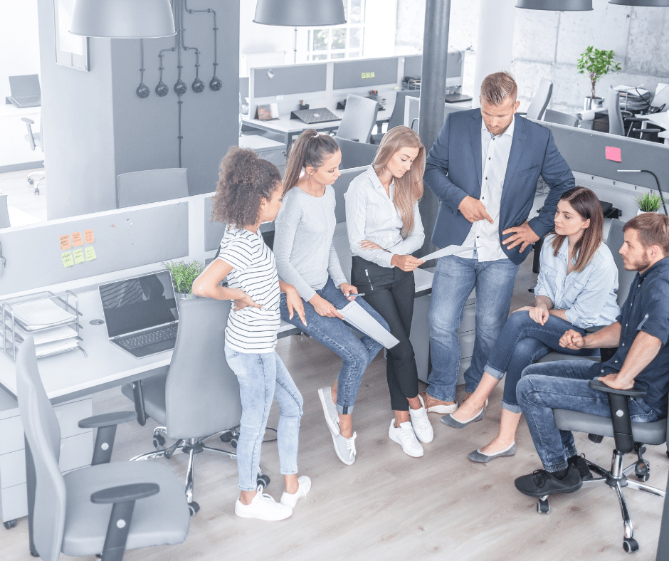 A group of people are standing around a table at CFO Network