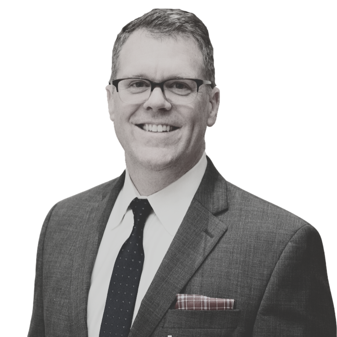A man in a suit and tie is smiling for the camera