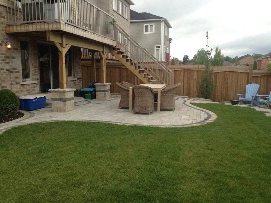 A backyard with a deck and stairs leading up to it