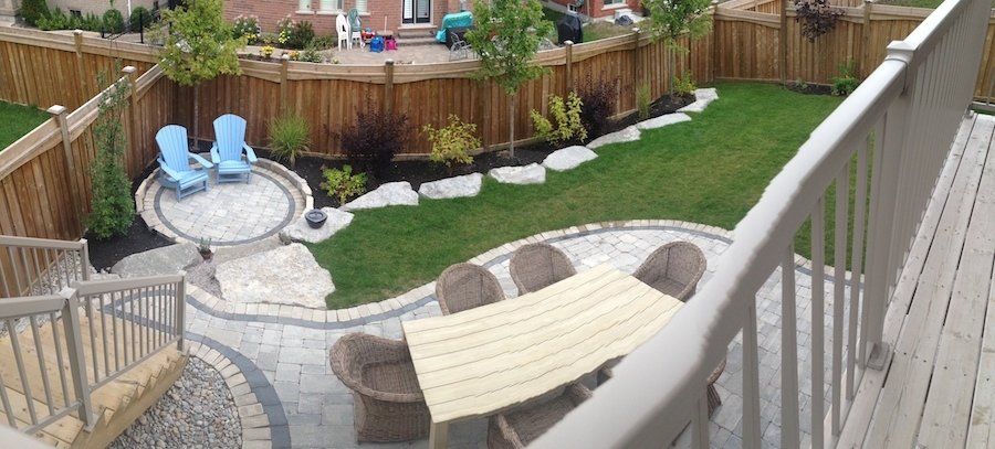 An aerial view of a backyard with a table and chairs.