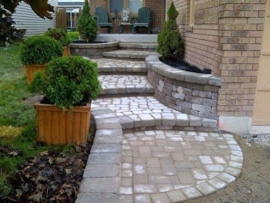 A brick walkway leading to the front door of a house.