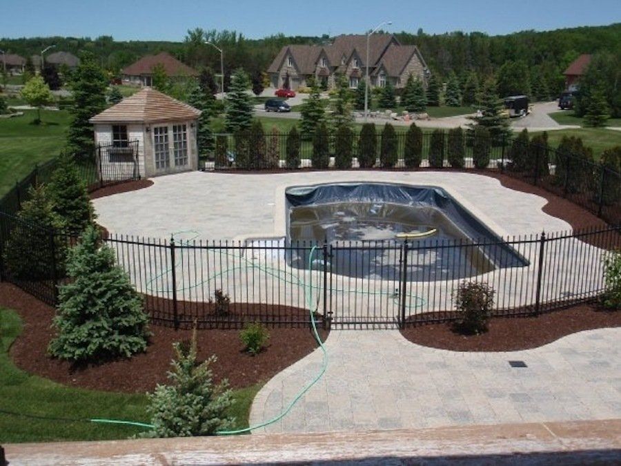 A large swimming pool with a fence around it