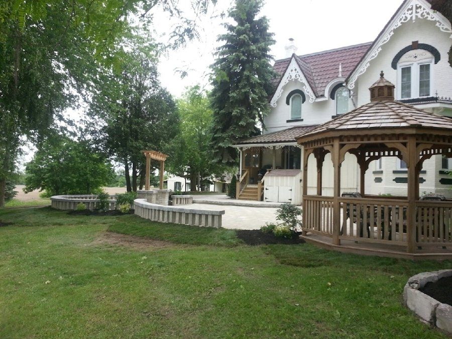A white house with a gazebo in front of it