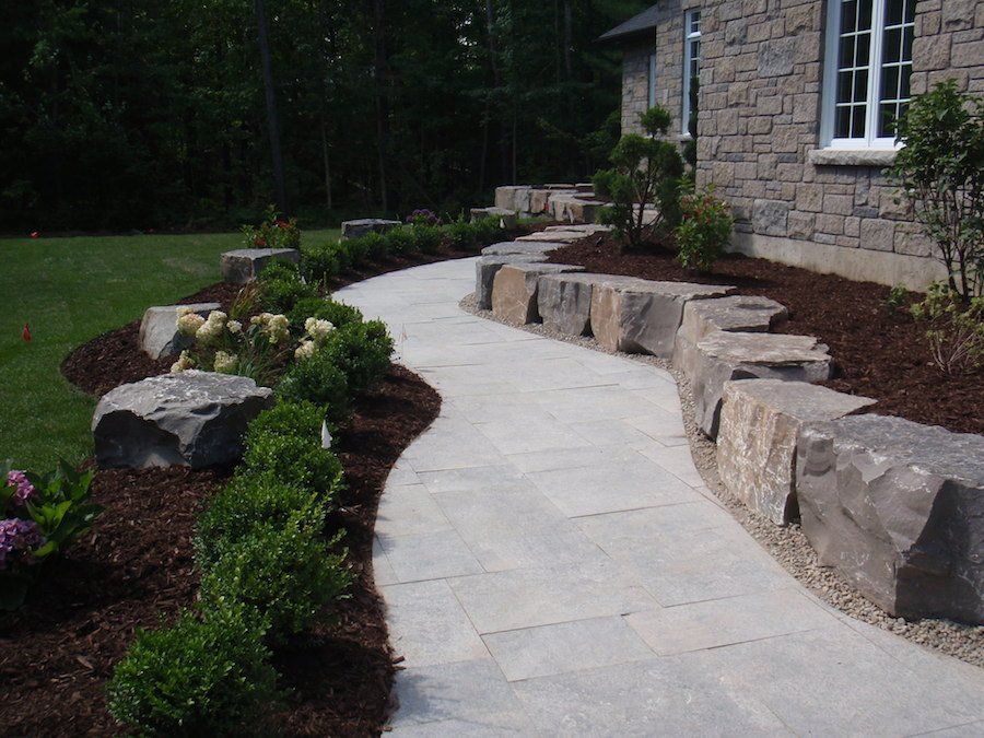 A stone walkway leading to a stone house