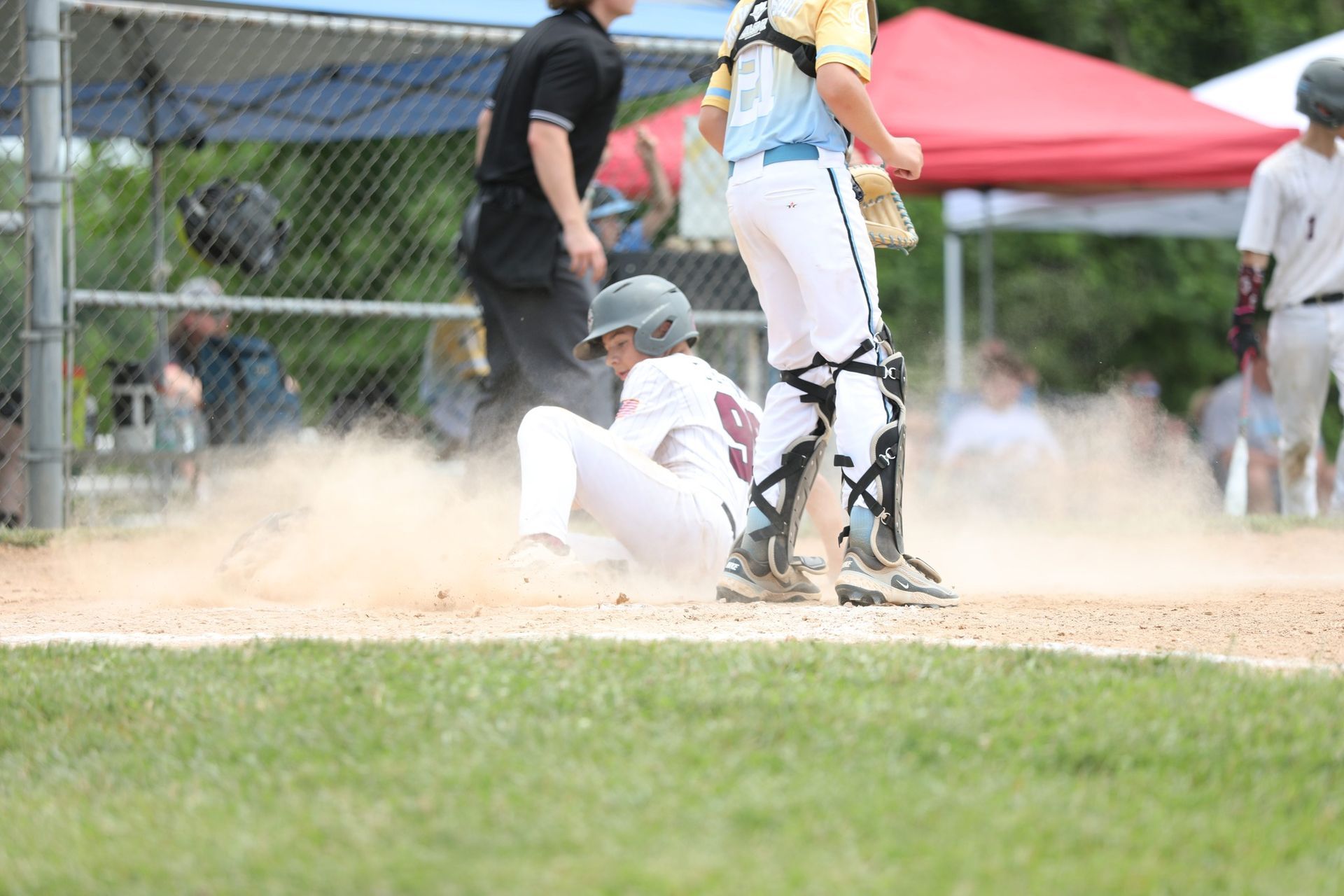 baseball player sliding into home