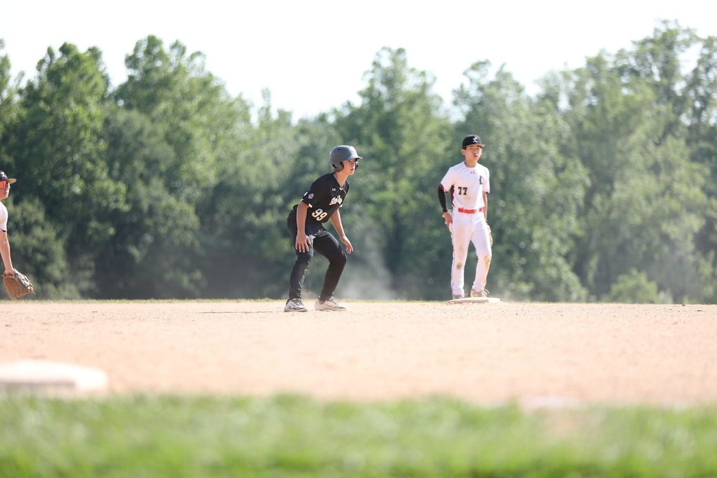 Youth baseball player leading off second base