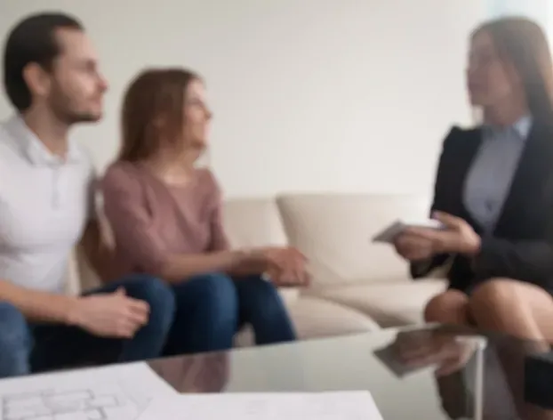 A Couple Are Talking With A Lawyer on a  Couch — McVittie Legal In Ballina, NSW