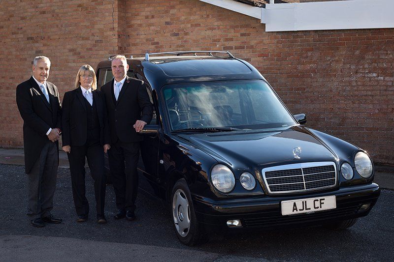 Funeral directors in Weston and Burnham in front of Hearse