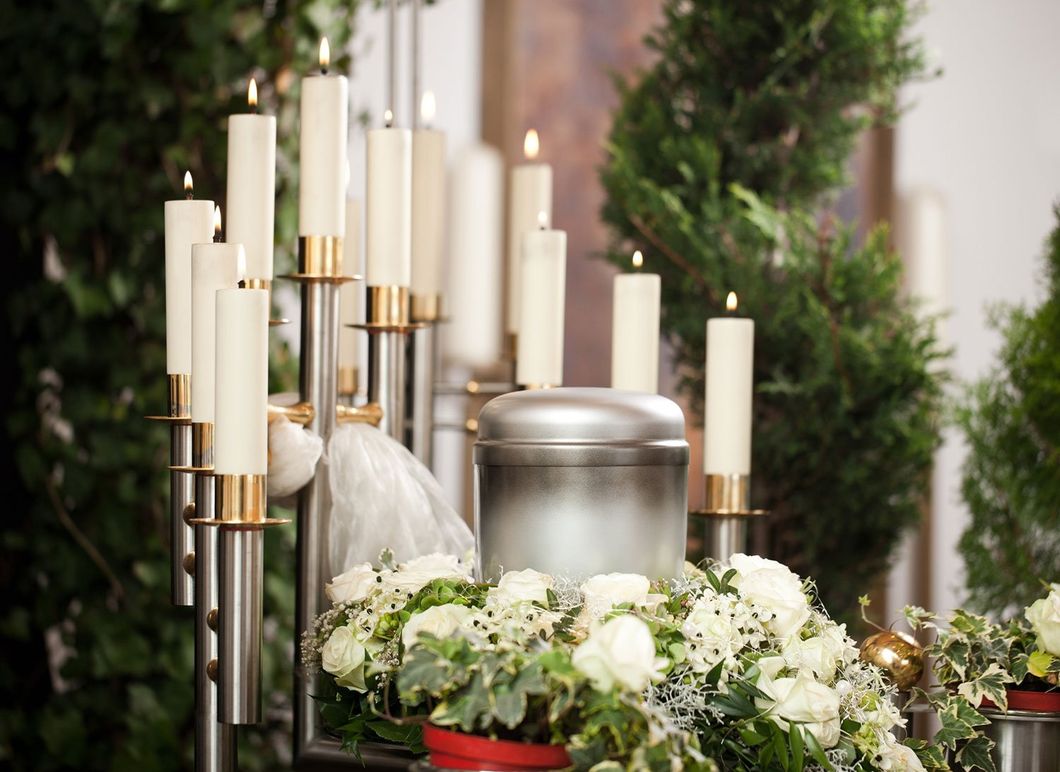 Lit candles at a funeral service with quote over the top