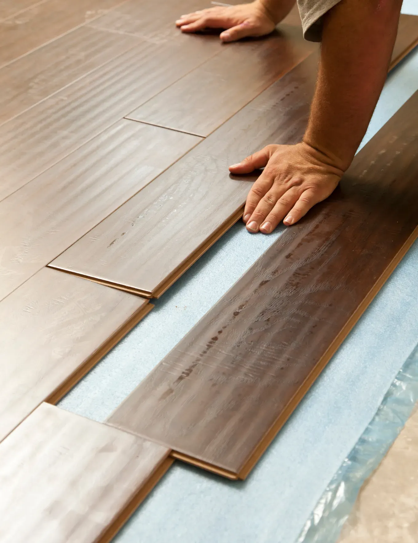 Hardwood flooring getting installed by experts at Blas Carpet in Atlanta, Georgia.