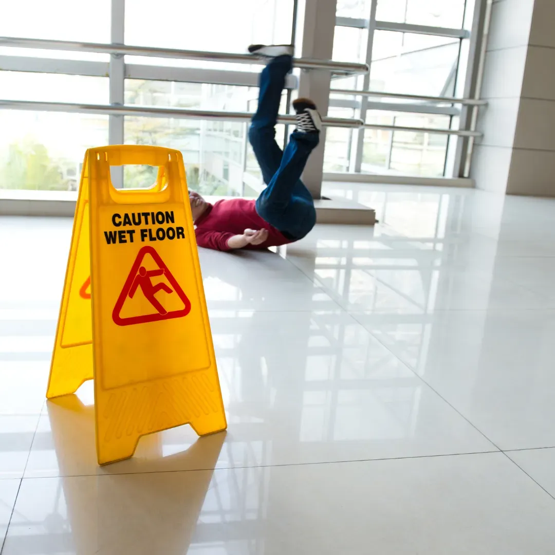 Guy falling due to wet floor without anti slip tile coating.
