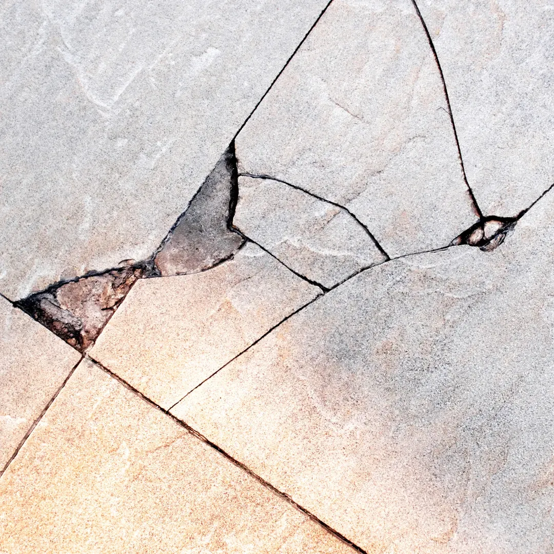 Cracked tile floor being repaired by BLAS specialist.