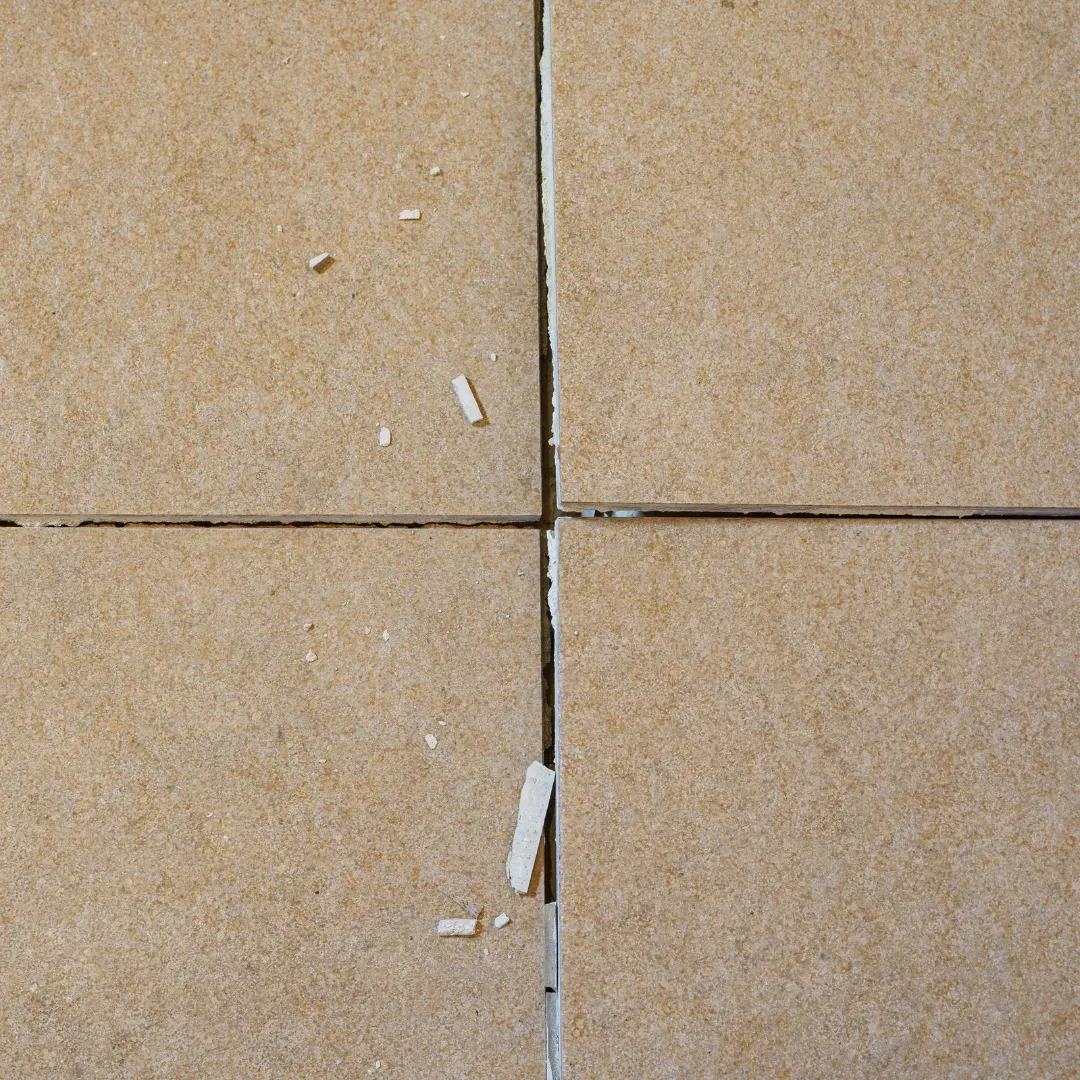 Cracked tile floor being repaired by BLAS specialist.