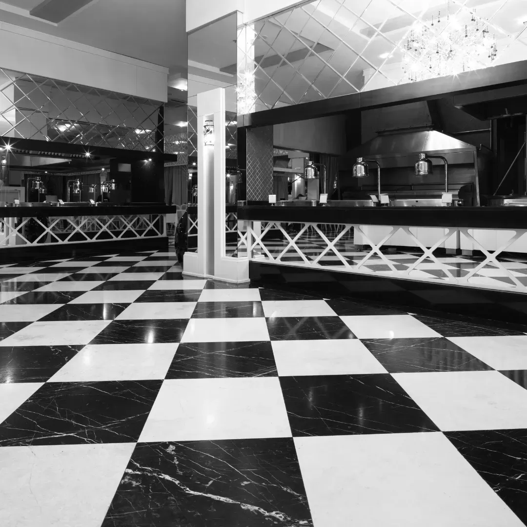 Ceramic tile floor design with black and white patterns inside kitchen.
