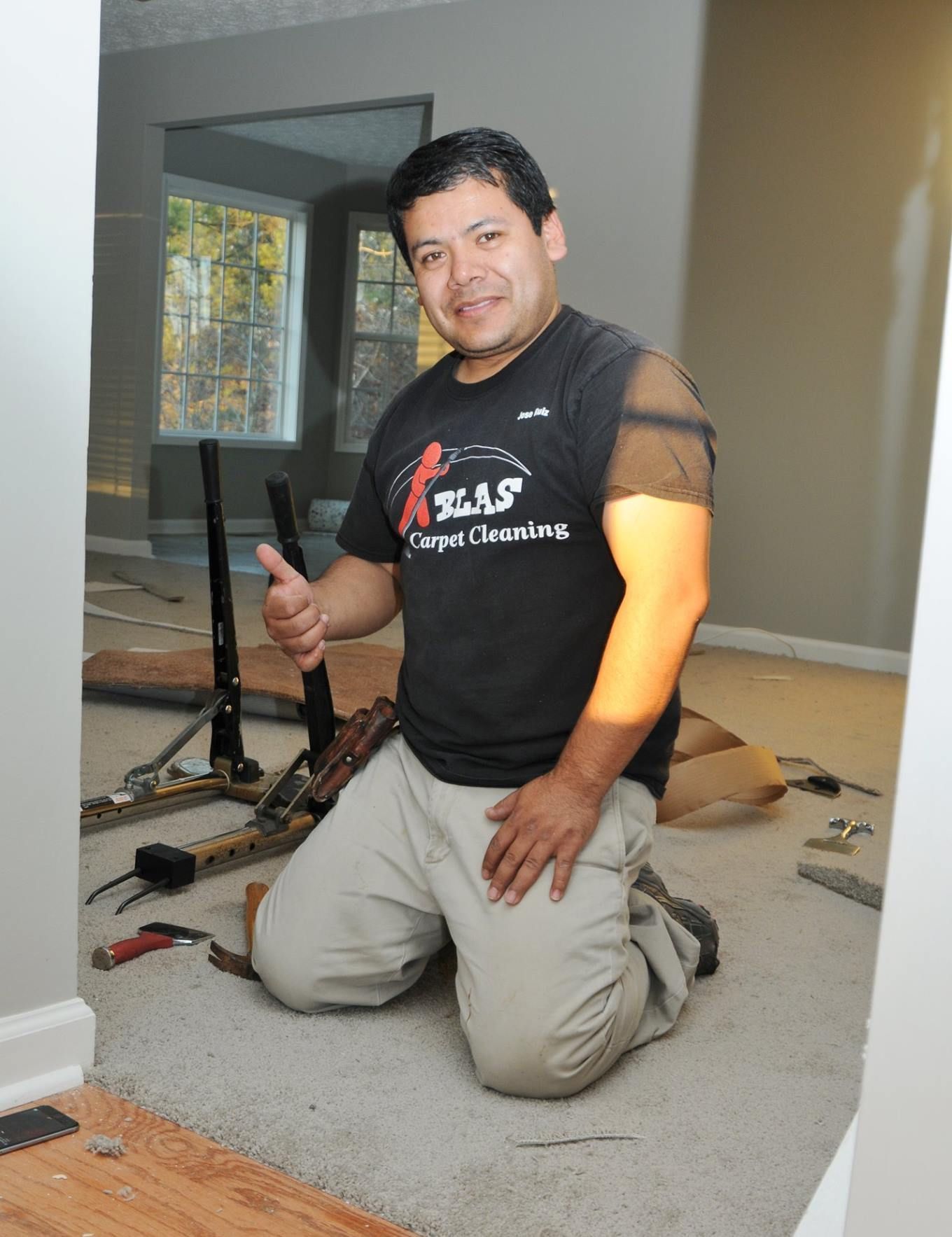 Professional carpet installation specialist removing old carpeting.