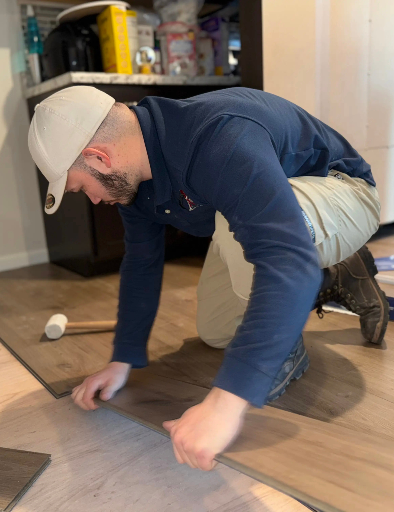 LVP flooring installation specialist laying down planks.