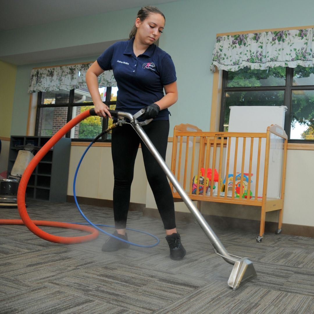 Professional steam carpet cleaning technician removing dirt from residential carpeting in Atlanta, Georgia.