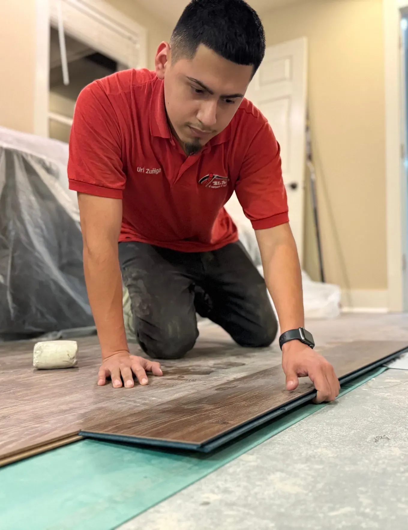 LVP flooring installation specialist laying down planks.