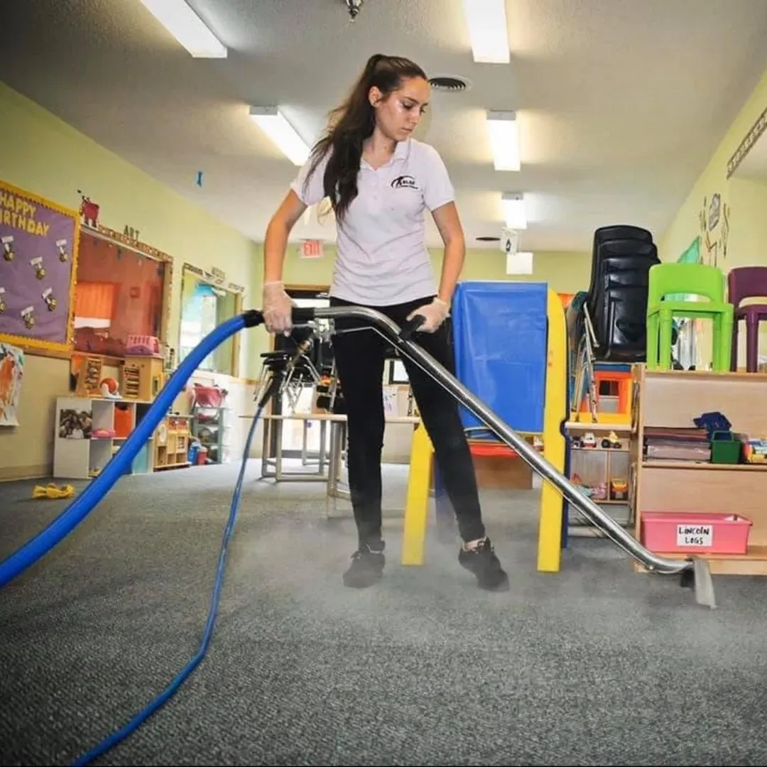 Professional cleaning technician performing steam carpet cleaning service.