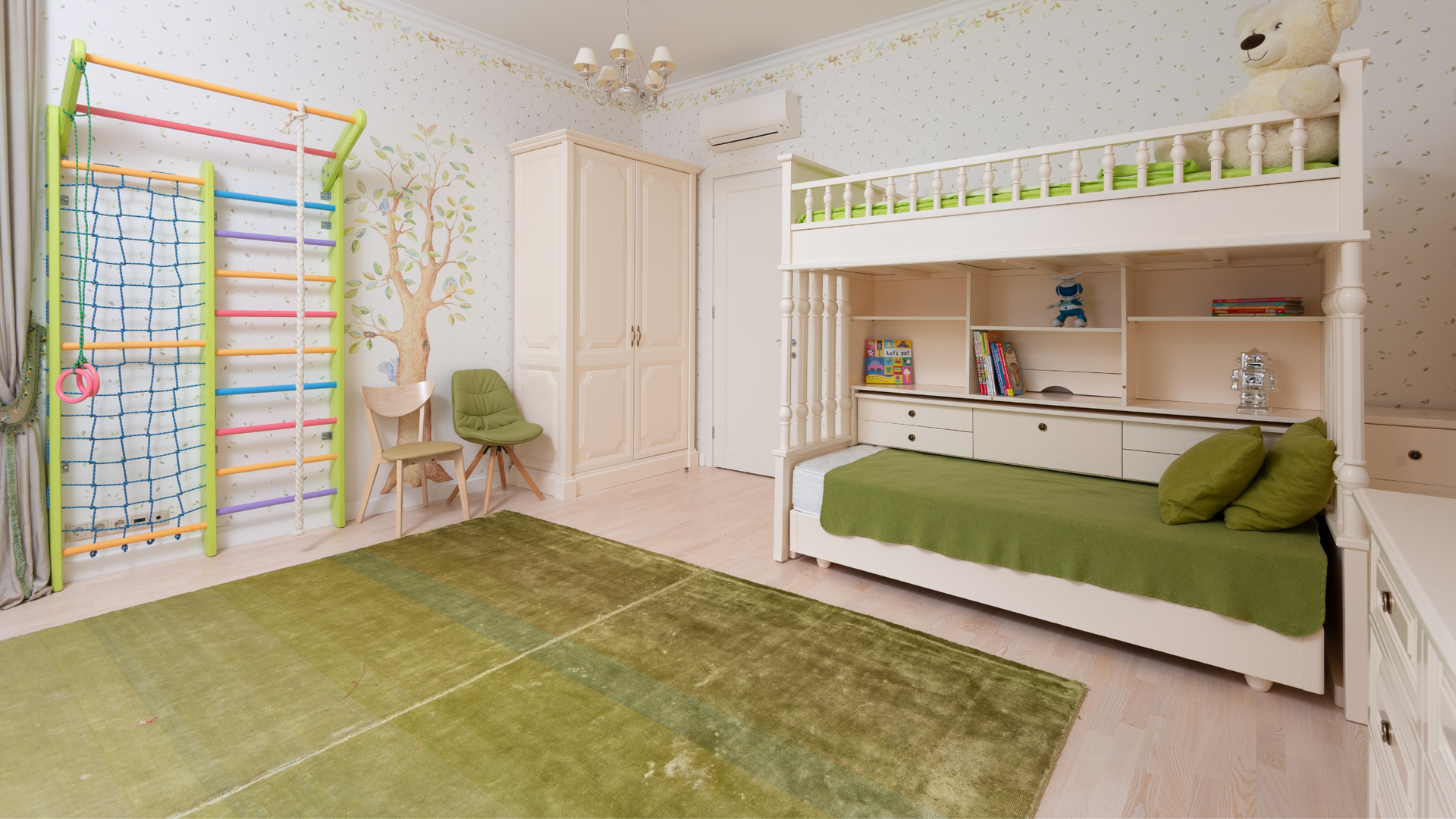 Children's bedroom furnished with green area rug, bunk beds, and toys.