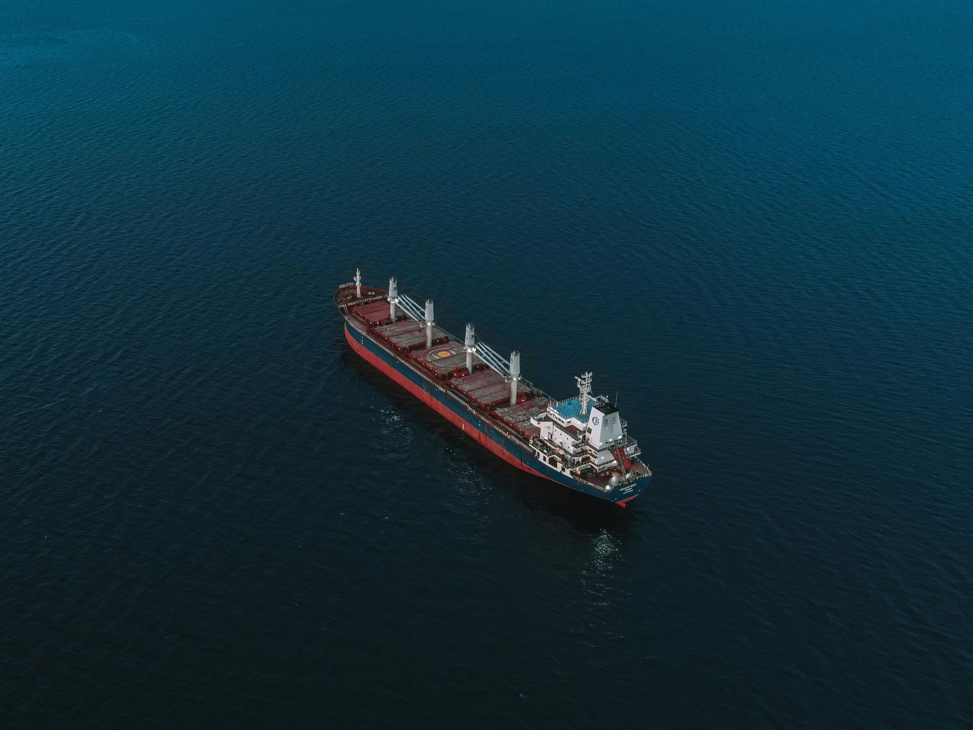 An aerial view of a large cargo ship in the ocean.