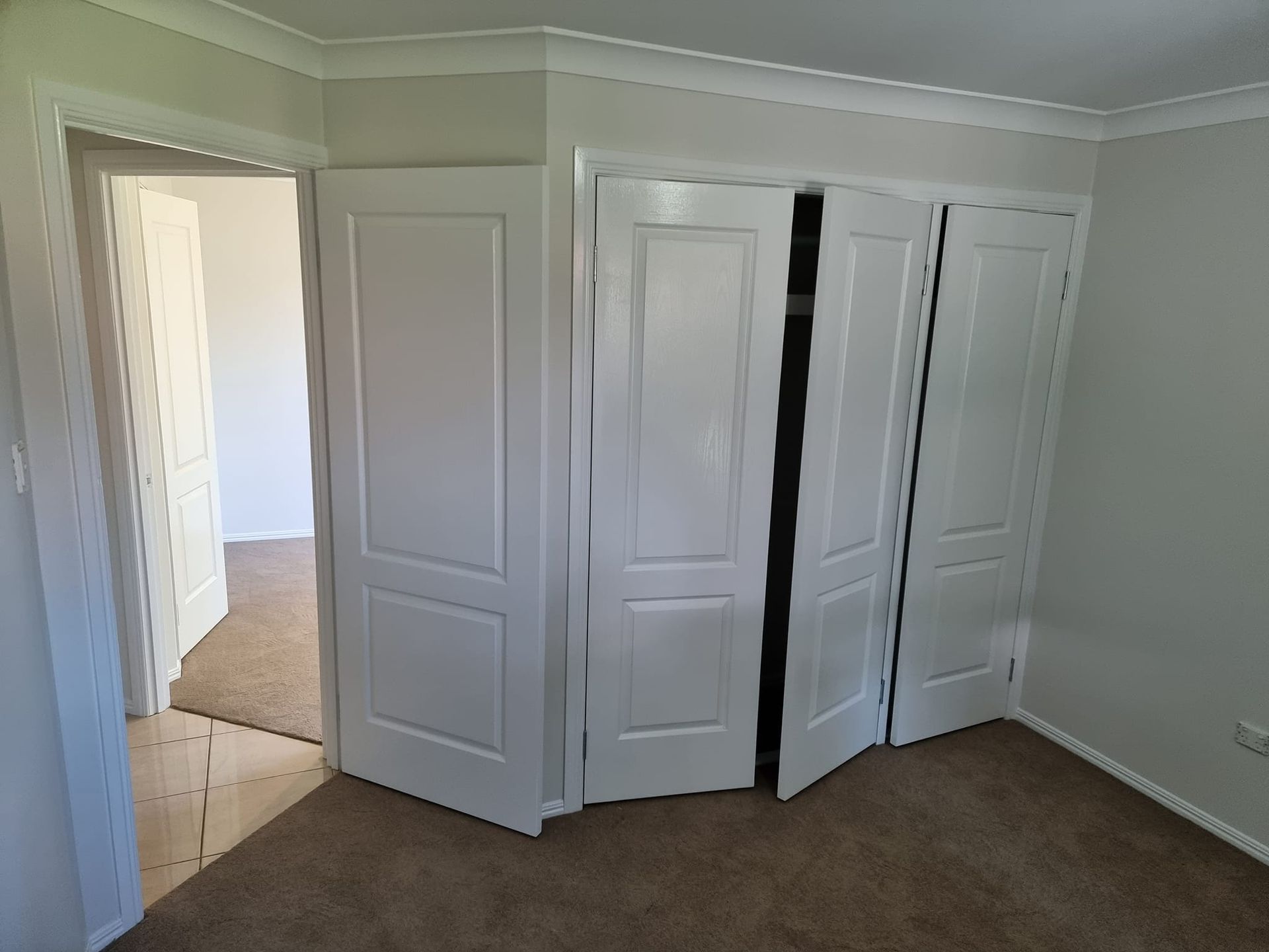 A Room With A Lot Of White Doors And A Door That Is Open — LMS Painting & Maintenance Pty Ltd In Cessnock, NSW