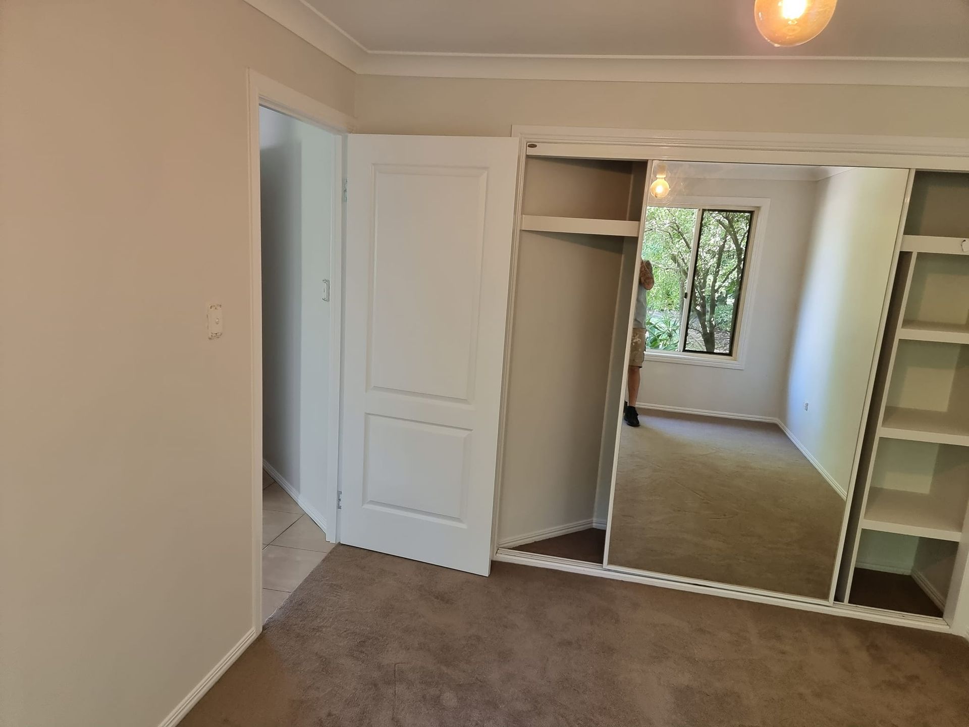 A Bedroom With A Large Mirror On The Wall — LMS Painting & Maintenance Pty Ltd In Nelson Bay, NSW