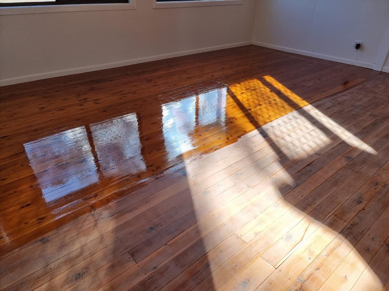 The Sun Is Shining Through The Windows On A Wooden Floor — LMS Painting & Maintenance Pty Ltd In Maitland, NSW