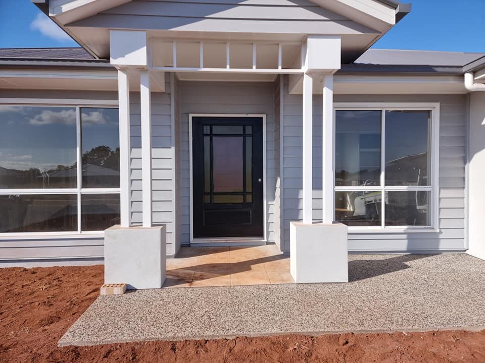 The Front Of A House With A Black Door And Windows — LMS Painting & Maintenance Pty Ltd In Newcastle, NSW