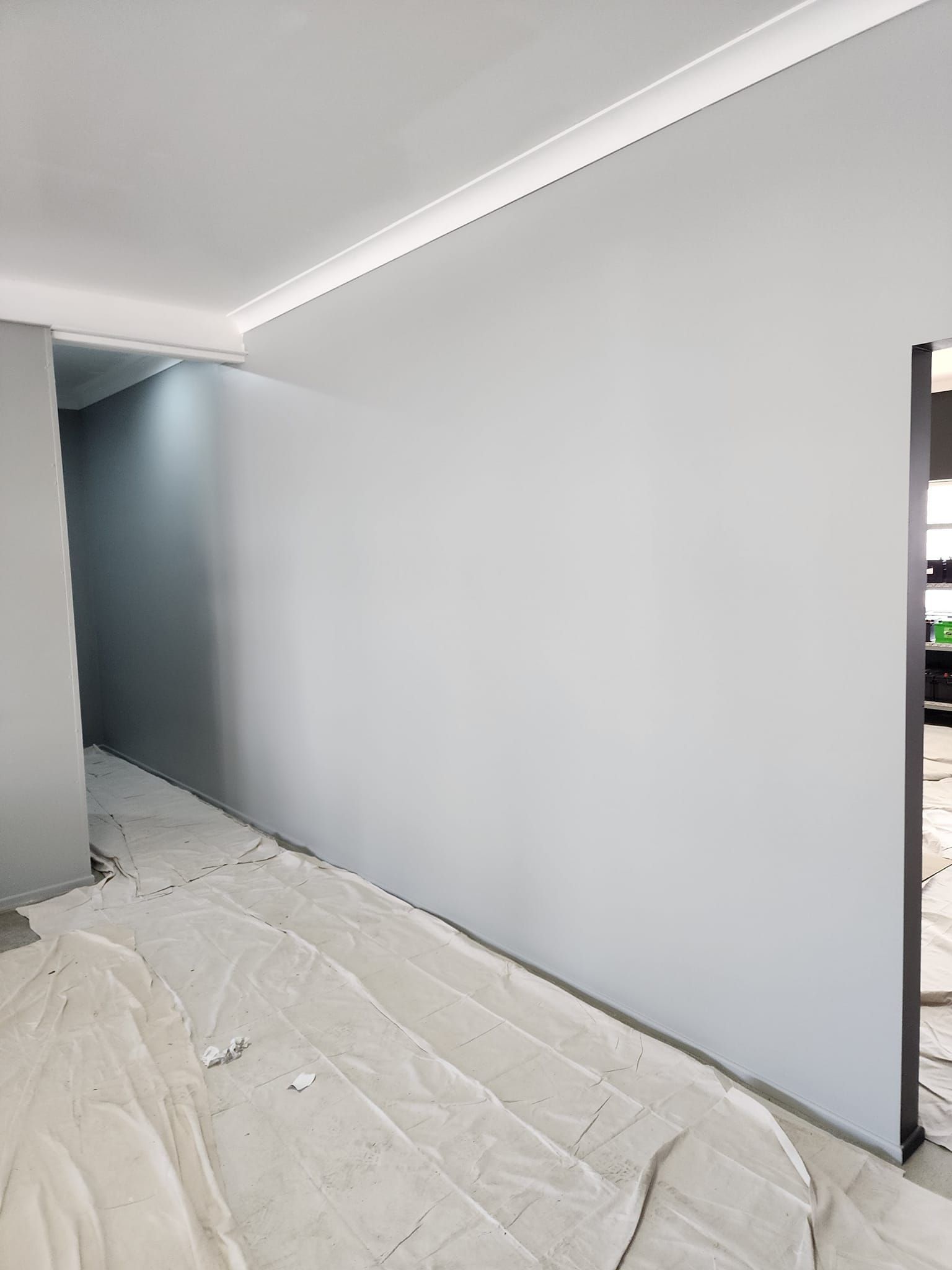 A Room With A White Wall And A White Tarp On The Floor — LMS Painting & Maintenance Pty Ltd In North Lambton, NSW