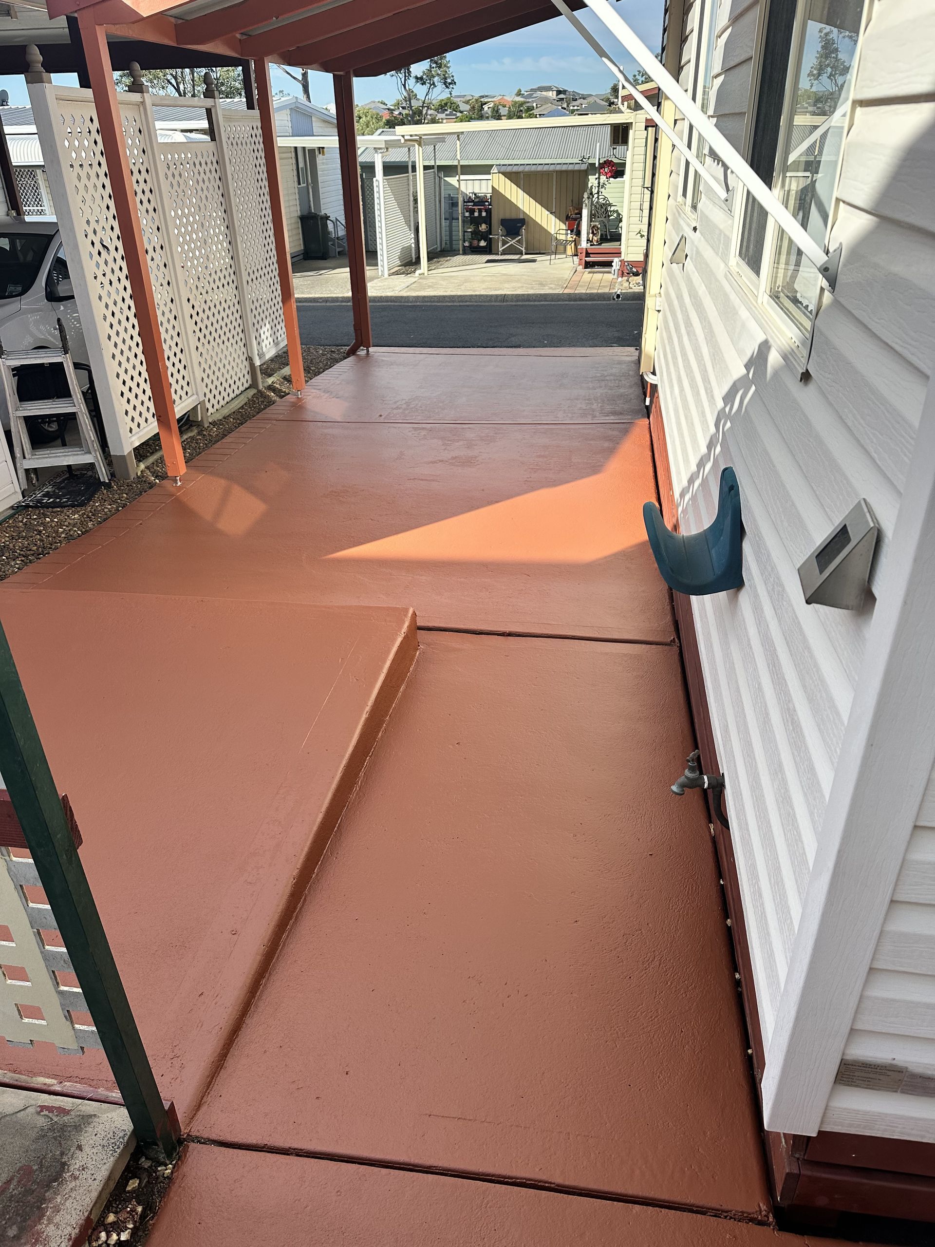 A concrete walkway leading to a mobile home with a covered porch — LMS Painting & Maintenance Pty Ltd In North Lambton, NSW